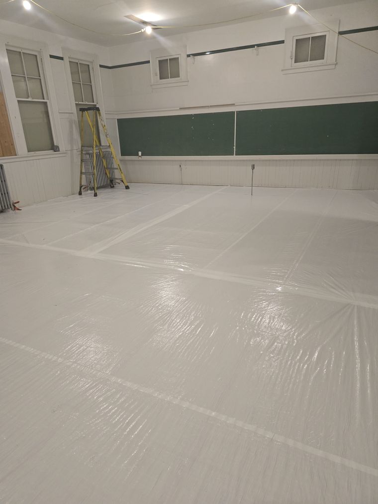 Poly-sheeted floor protection on an abatement job